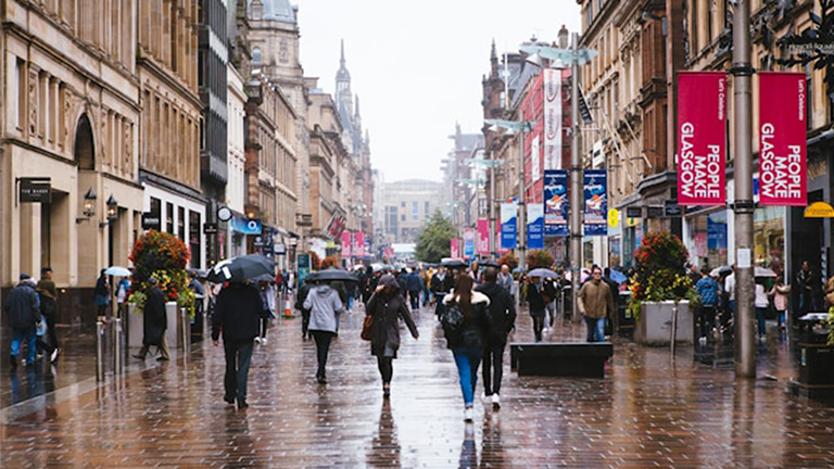 A rainy photo of people walking on Buchanan Street in Glasgow city centre