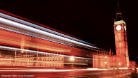 A timelapse photo of the UK Parliament building with car lights blurring past