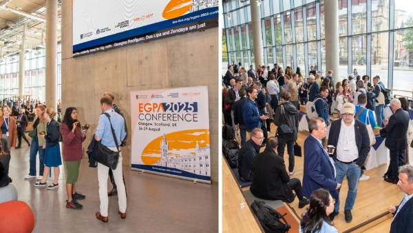 A photo of people standing next to the EGPA branded banner and networking