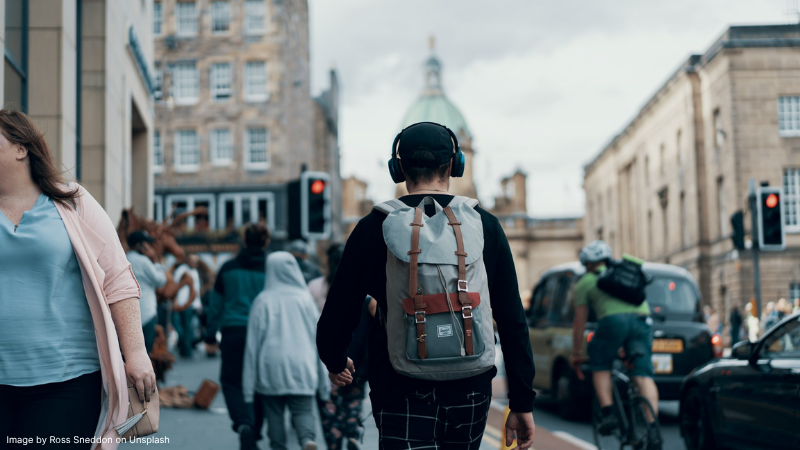 Person walking with backpack on in city