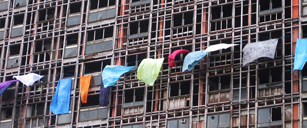 sheets hanging out of windows on a high rise flat
