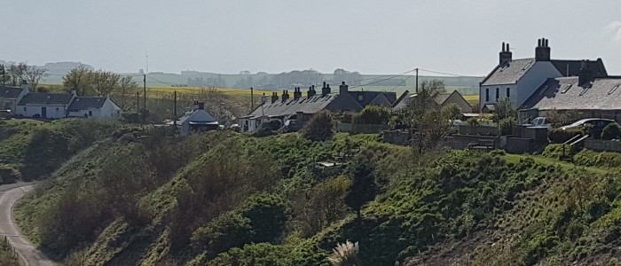 Homes at the top of cliff top above sea in Catterline. Photo credit: Dr. Karen Munro